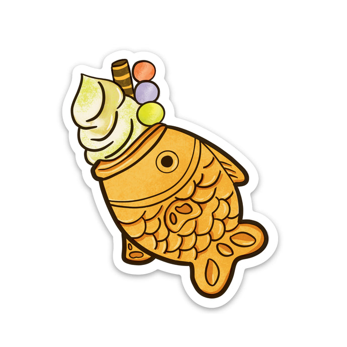 A taiyaki ice cream cone with a scoop of ice cream and dango in a taiyaki fish dessert vinyl sticker measuring 2 x 3 inches 