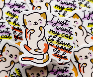 A cat illustration with hand drawn lettering that says &quot;I just want my cat to have a good life&quot; to the right of the sticker&quot;